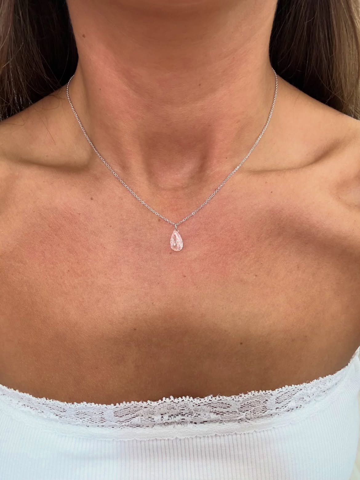 Pink pear shaped Floating Diamond necklace worn on a delicate chain