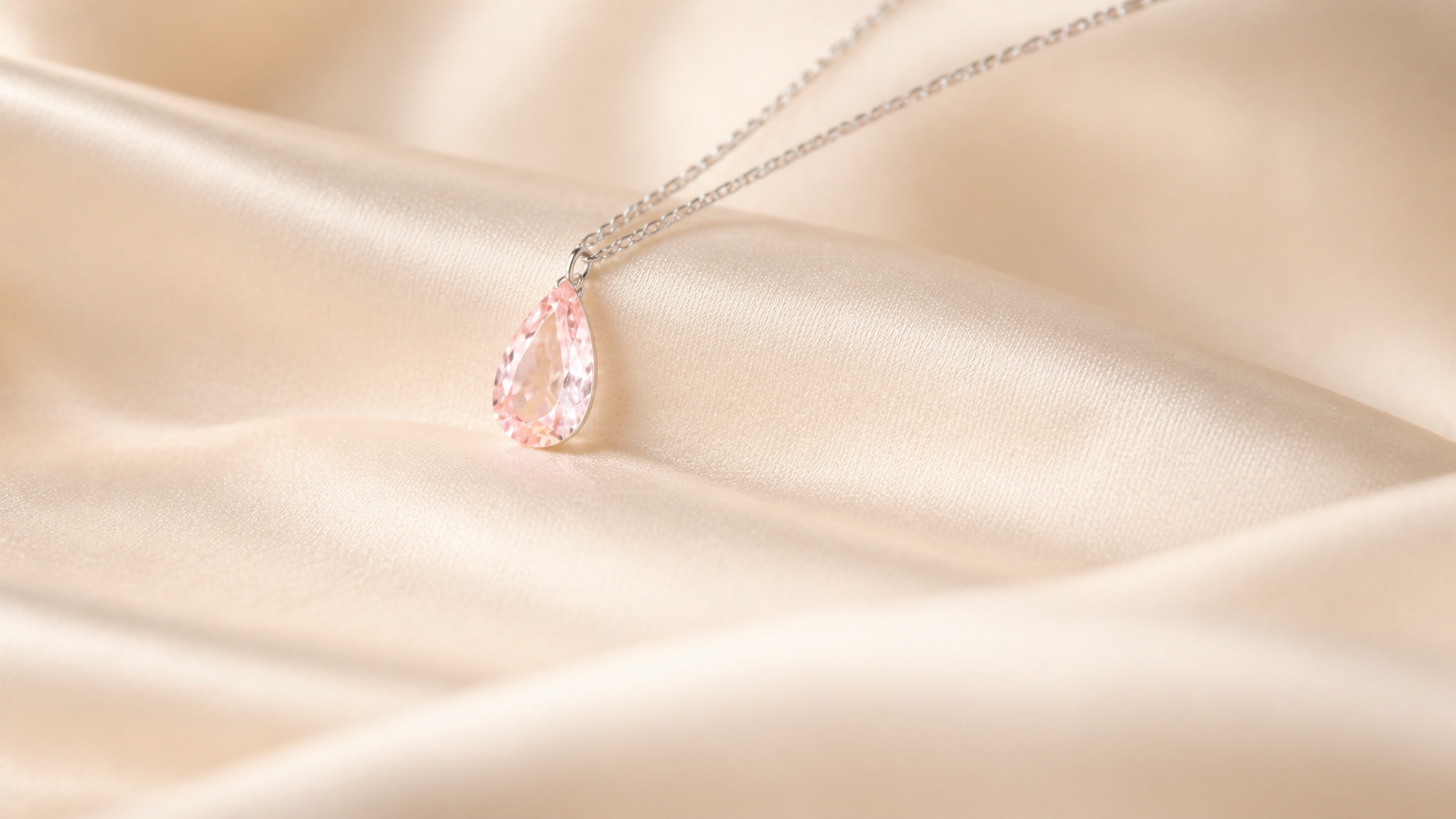 Pink pear shaped Floating Diamond resting on ivory silk