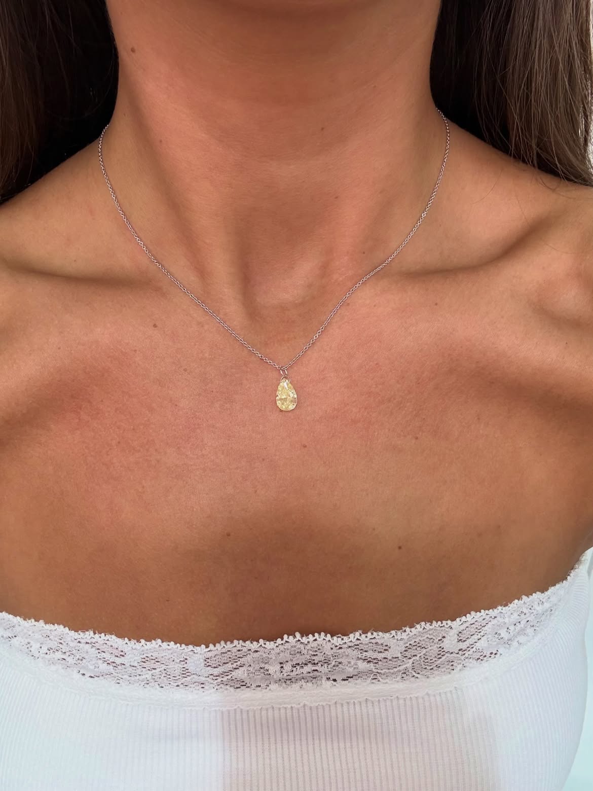 Yellow pear shaped Floating Diamond necklace worn on a delicate chain